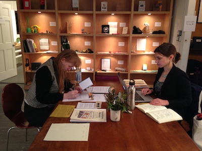 Eliza Martin consults with the Work Intern (Meredith Degyansky, right)